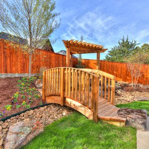 Residential bridge over backyard hardscaping project