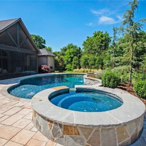 Backyard pool with hot tub and landscaping