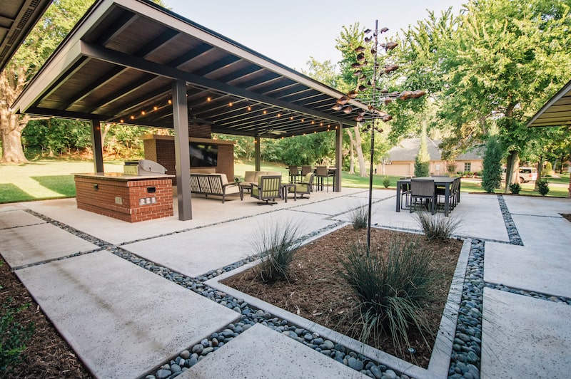 Concrete patio lined with rocks by Nelson Landscaping in Oklahoma