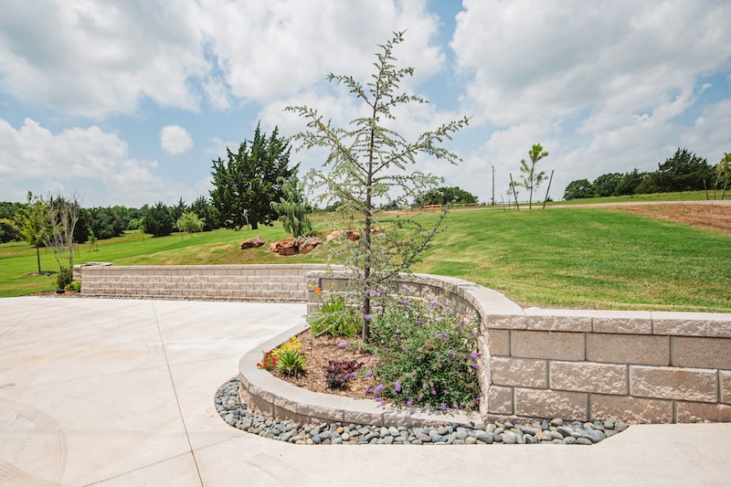 Boulder wall and rock lined landscape by Nelson Landscaping in Oklahoma 