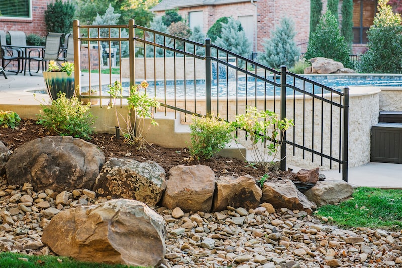 Poolside boulder and rock landscaping by Nelson Landscaping in Oklahoma