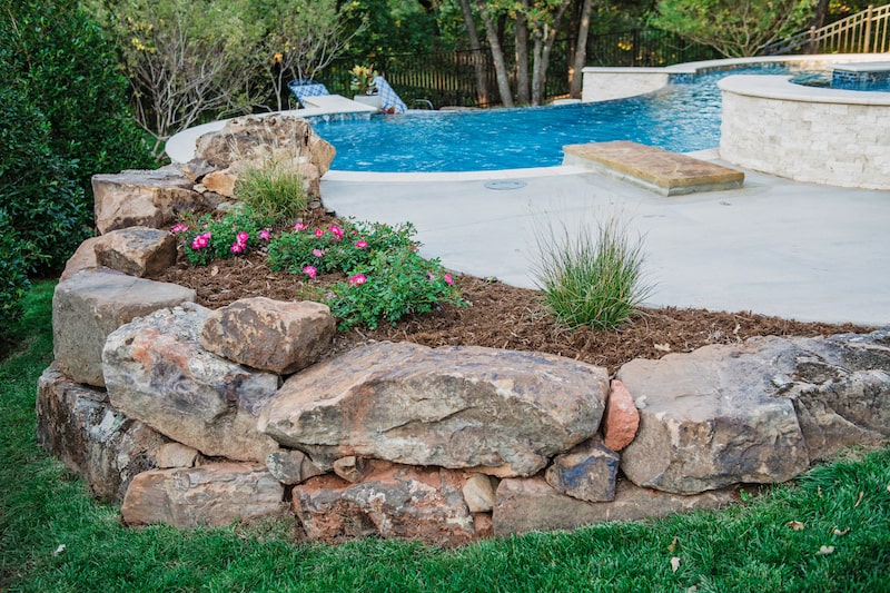 poolside boulder wall by Nelson Landscaping in Oklahoma
